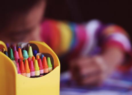 Criança colorindo com giz de cera (crédito: Aaron Burden/unsplash)